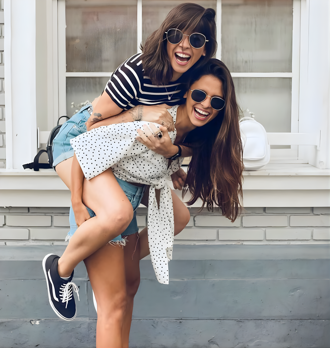 Two women enjoying a piggyback ride on a porch